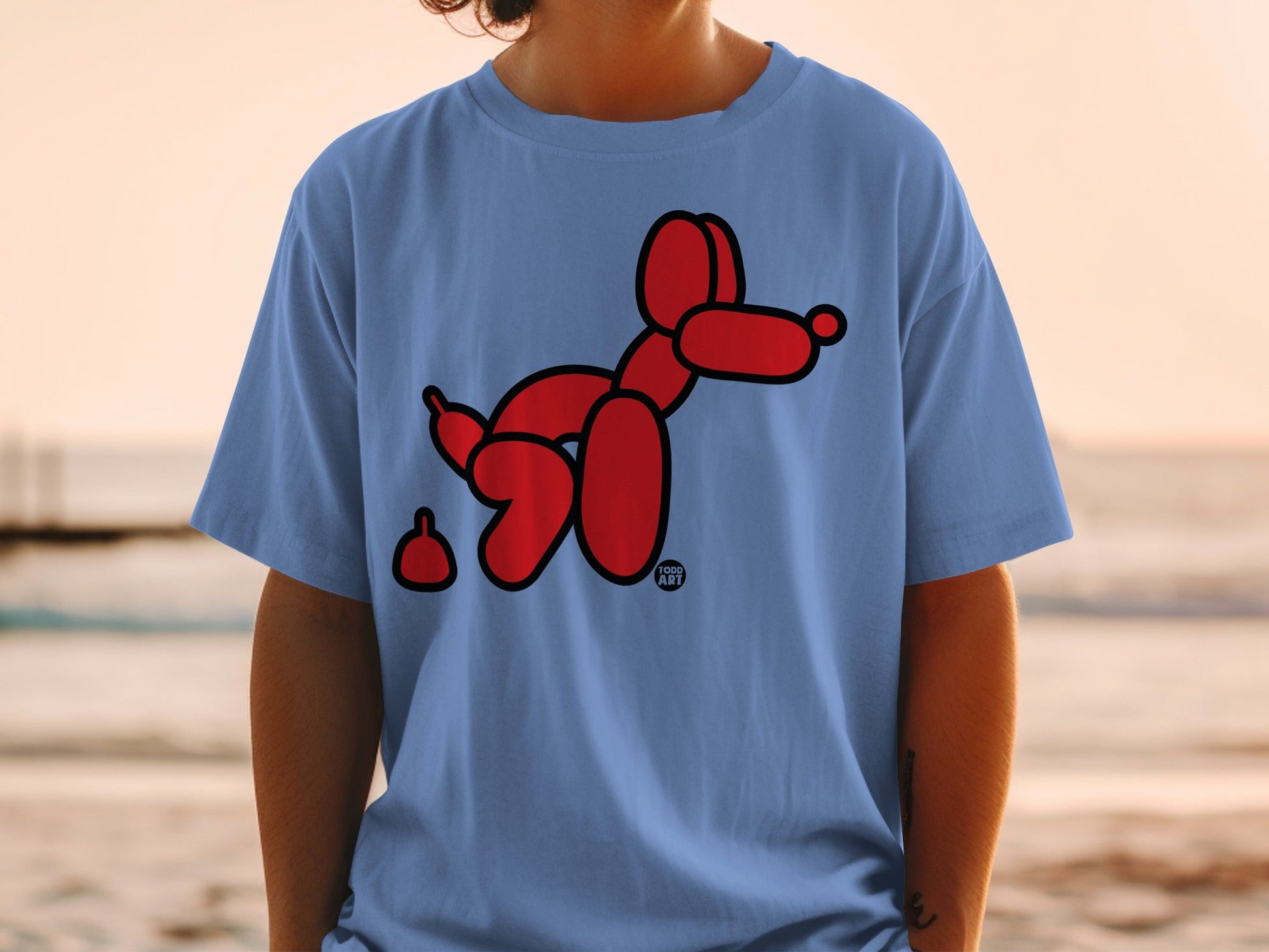 Blue t-shirt with a red balloon dog and its droppings.
