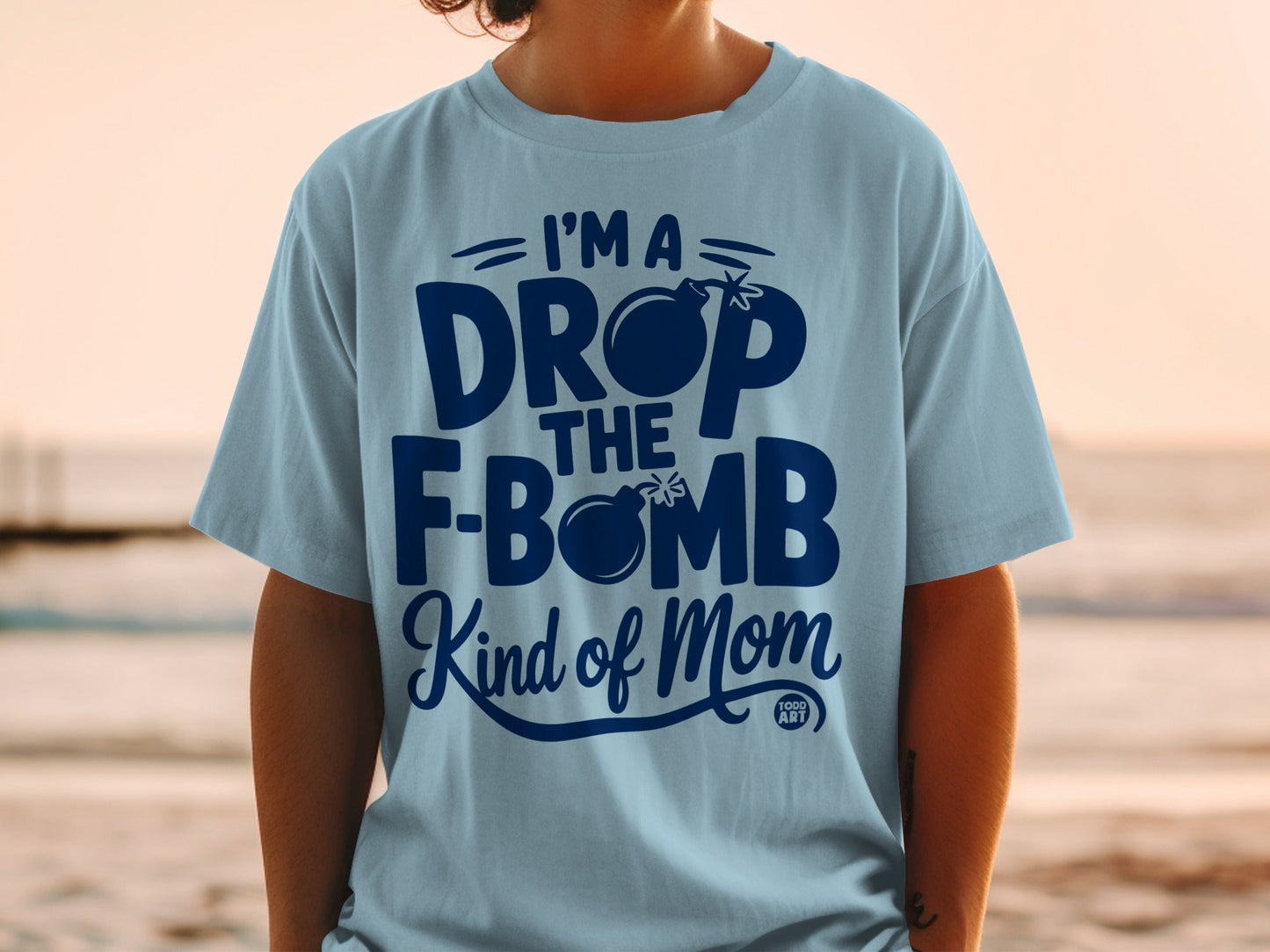Light blue t-shirt with dark blue text and a bomb graphic.