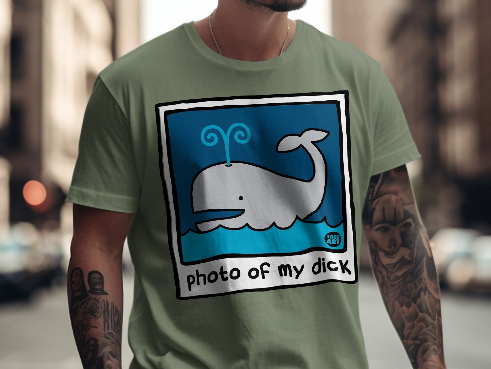 Grey cartoon whale spouting blue water with text "photo of my dick"