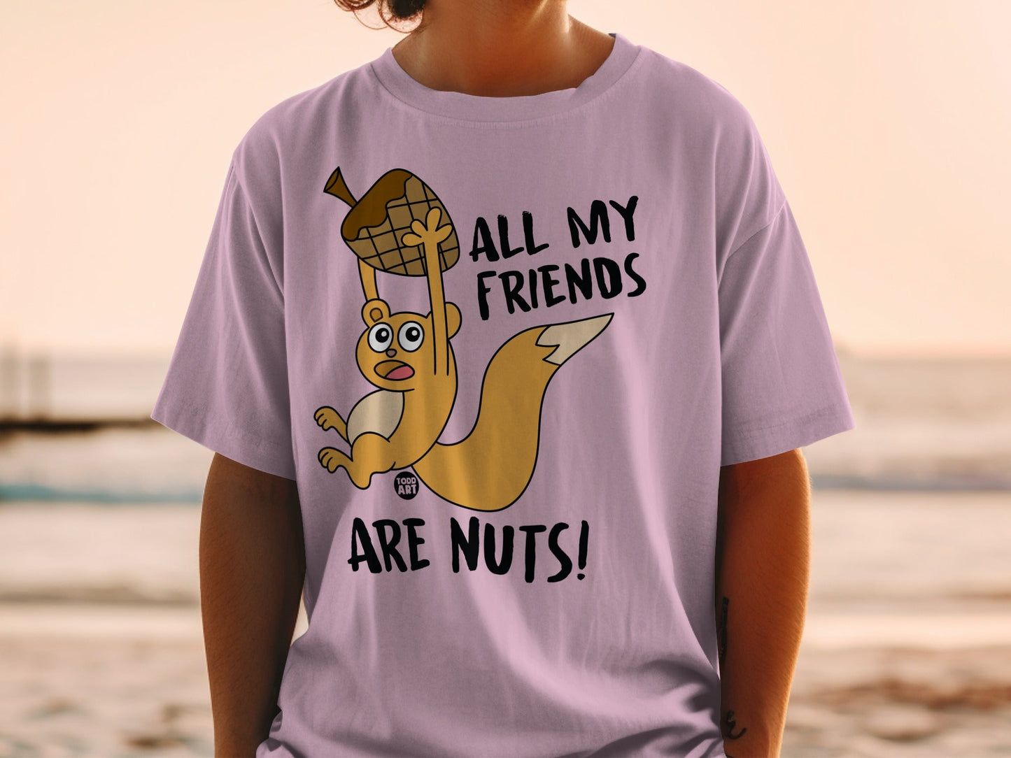 T-shirt with a cartoon squirrel holding an acorn and text "ALL MY FRIENDS ARE NUTS!".