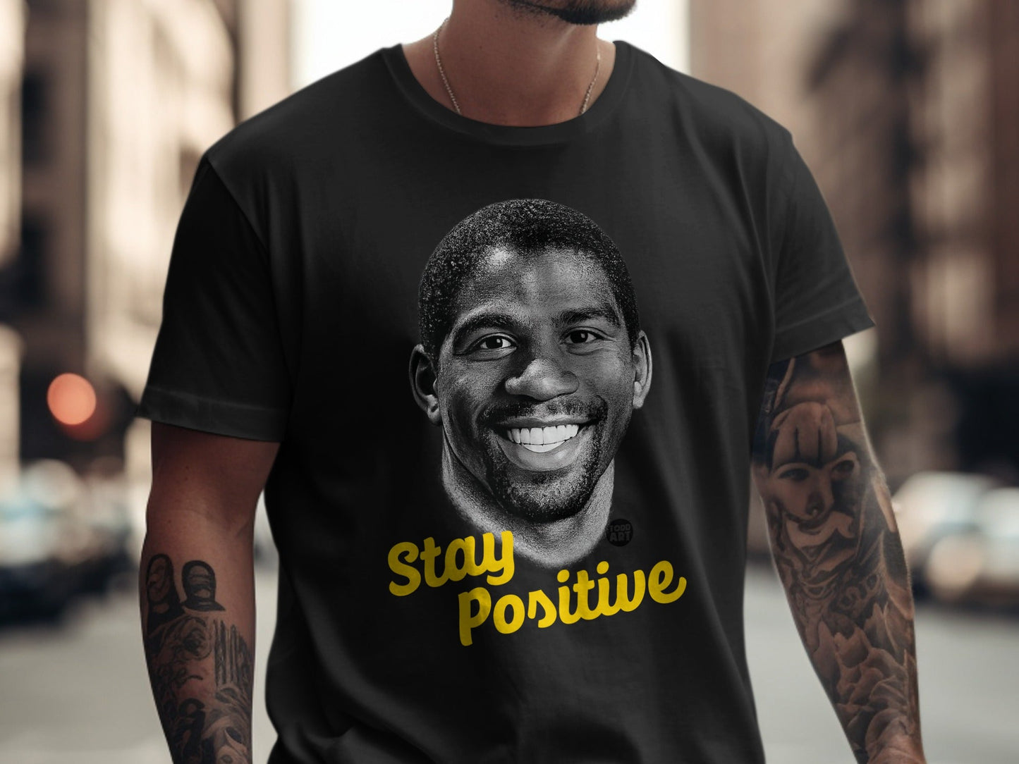 Black t-shirt with Magic Johnson portrait and "Stay Positive" text.