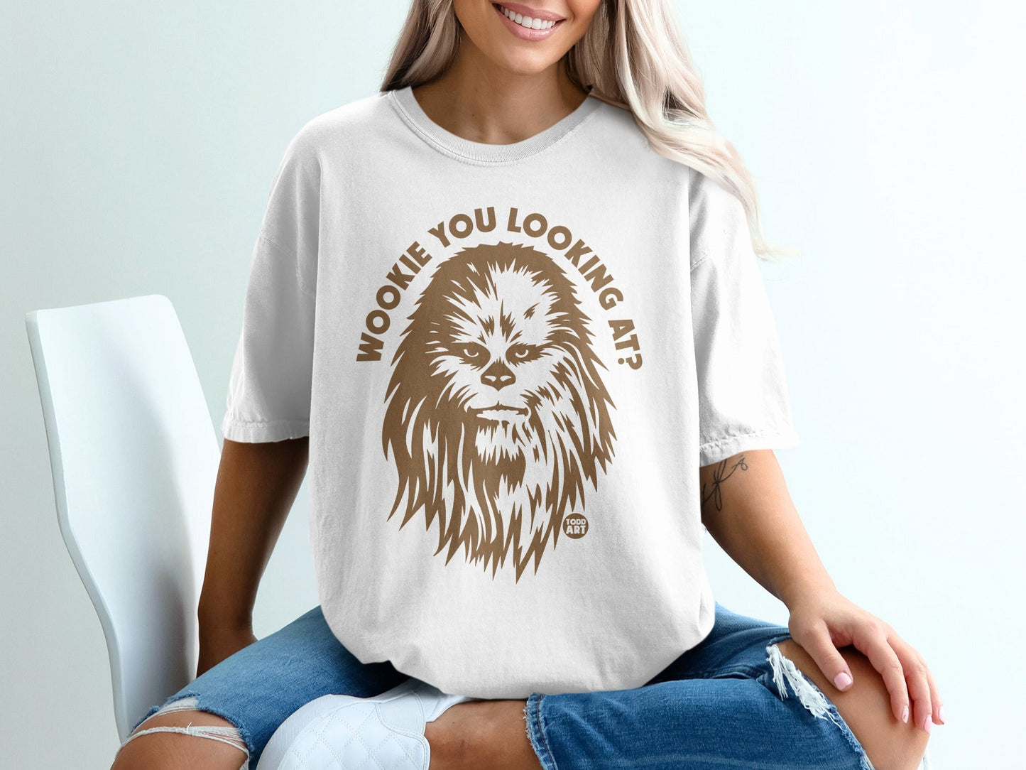 White t-shirt with brown Chewbacca graphic and "Wookiee you looking at?" text.