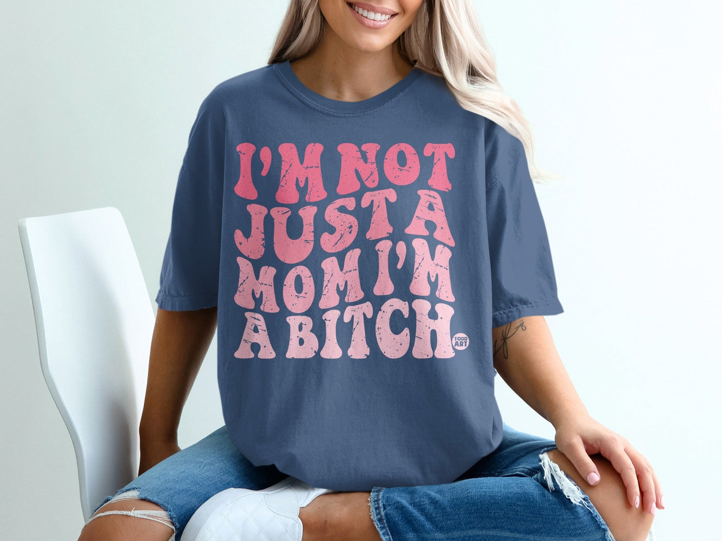 Blue t-shirt with "I'm not just a mom, I'm a bitch" in pink text.