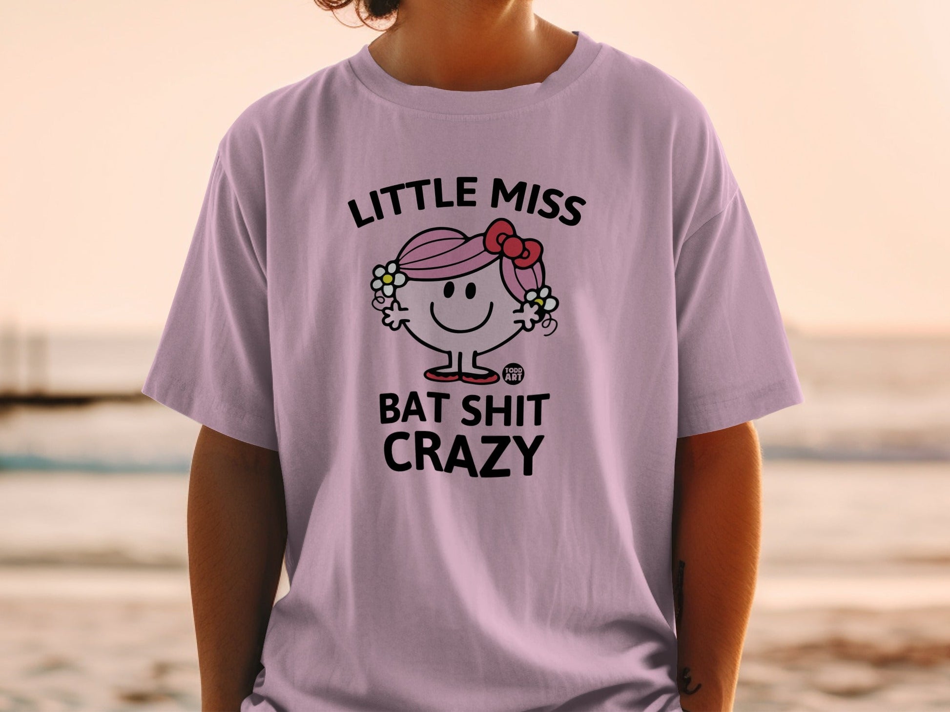 Light purple t-shirt with "Little Miss Bat Shit Crazy" graphic.