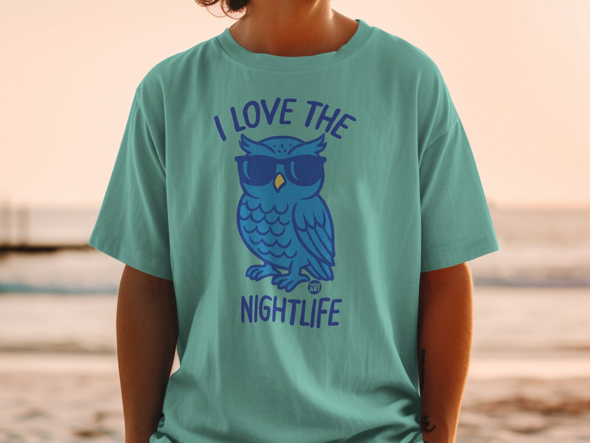 Teal t-shirt with blue owl wearing sunglasses and text "I LOVE THE NIGHTLIFE".
