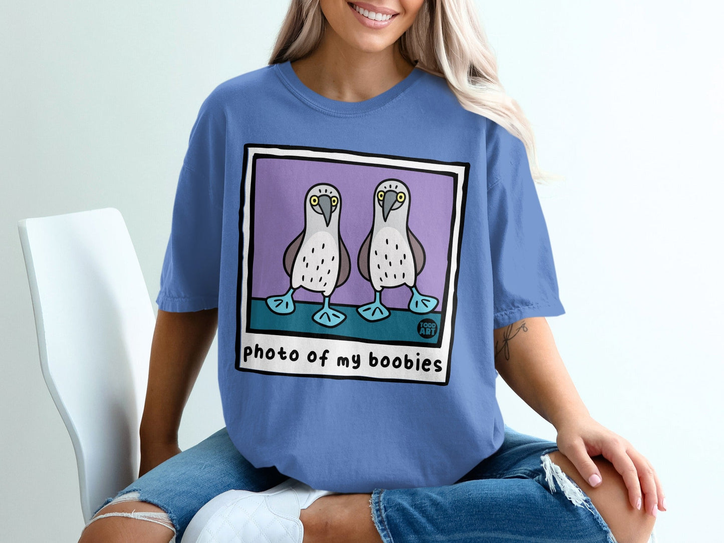 Blue t-shirt with a polaroid-style graphic of two boobies and text "photo of my boobies".