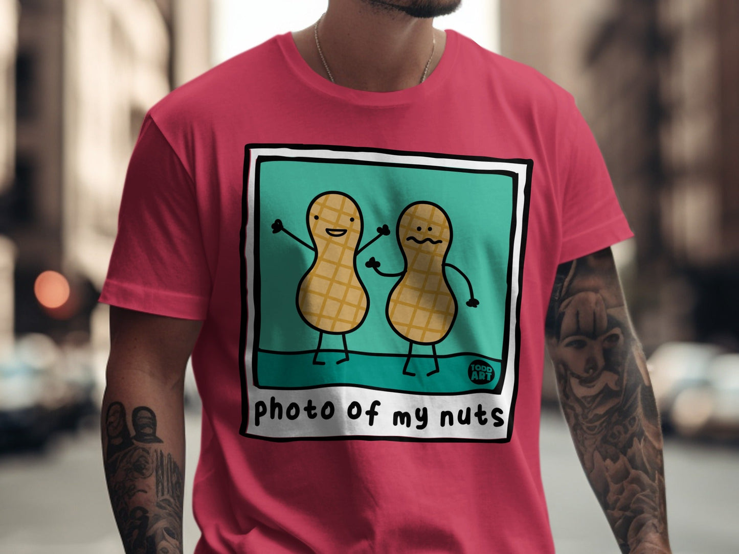 Two cartoon peanuts with arms raised on a pink t-shirt.