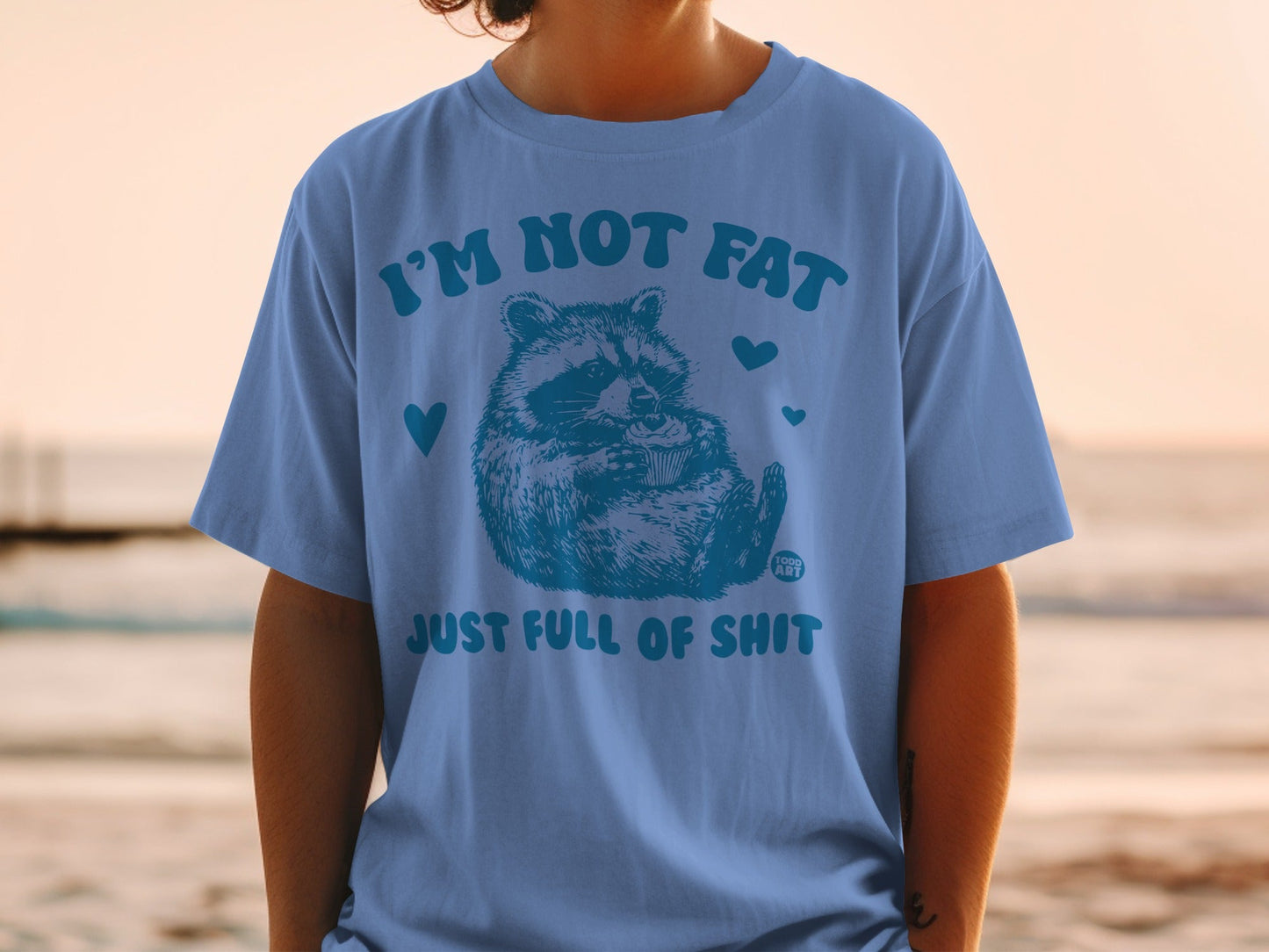 Blue t-shirt with a raccoon and text "I'M NOT FAT JUST FULL OF SHIT".