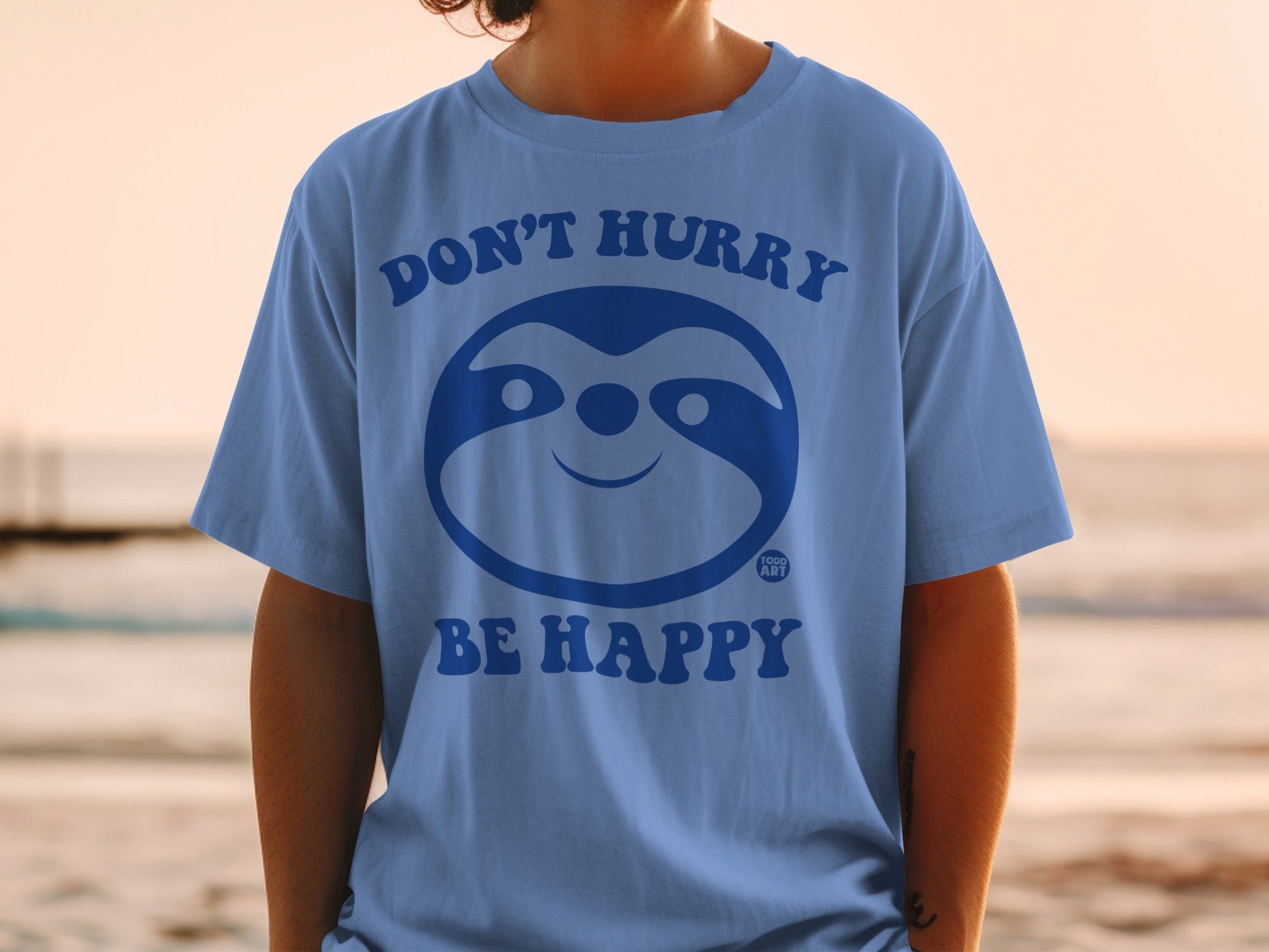 Blue t-shirt with a sloth face and "DON'T HURRY BE HAPPY" text.