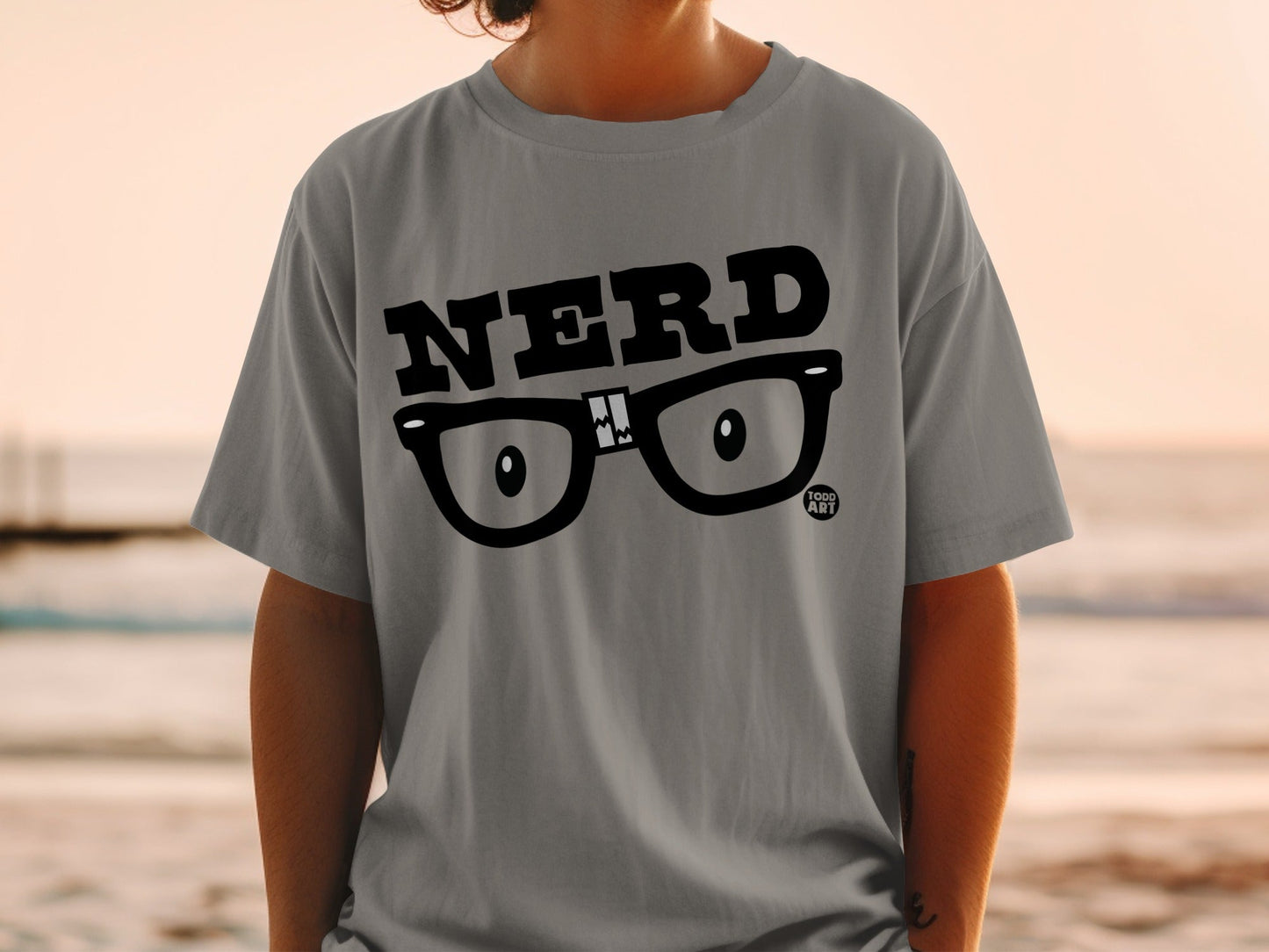 Grey t-shirt with black "NERD" text and eyeglasses graphic.
