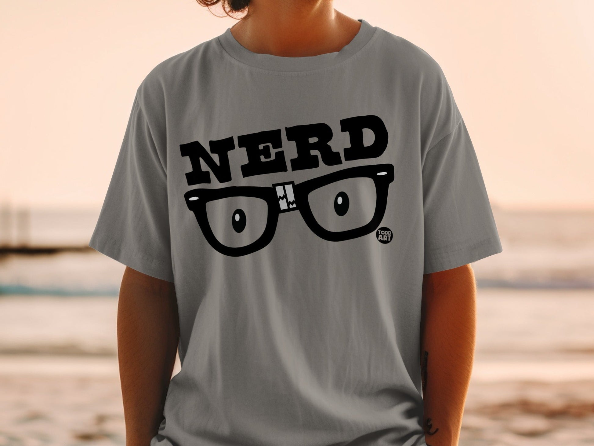 Grey t-shirt with black "NERD" text and eyeglasses graphic.