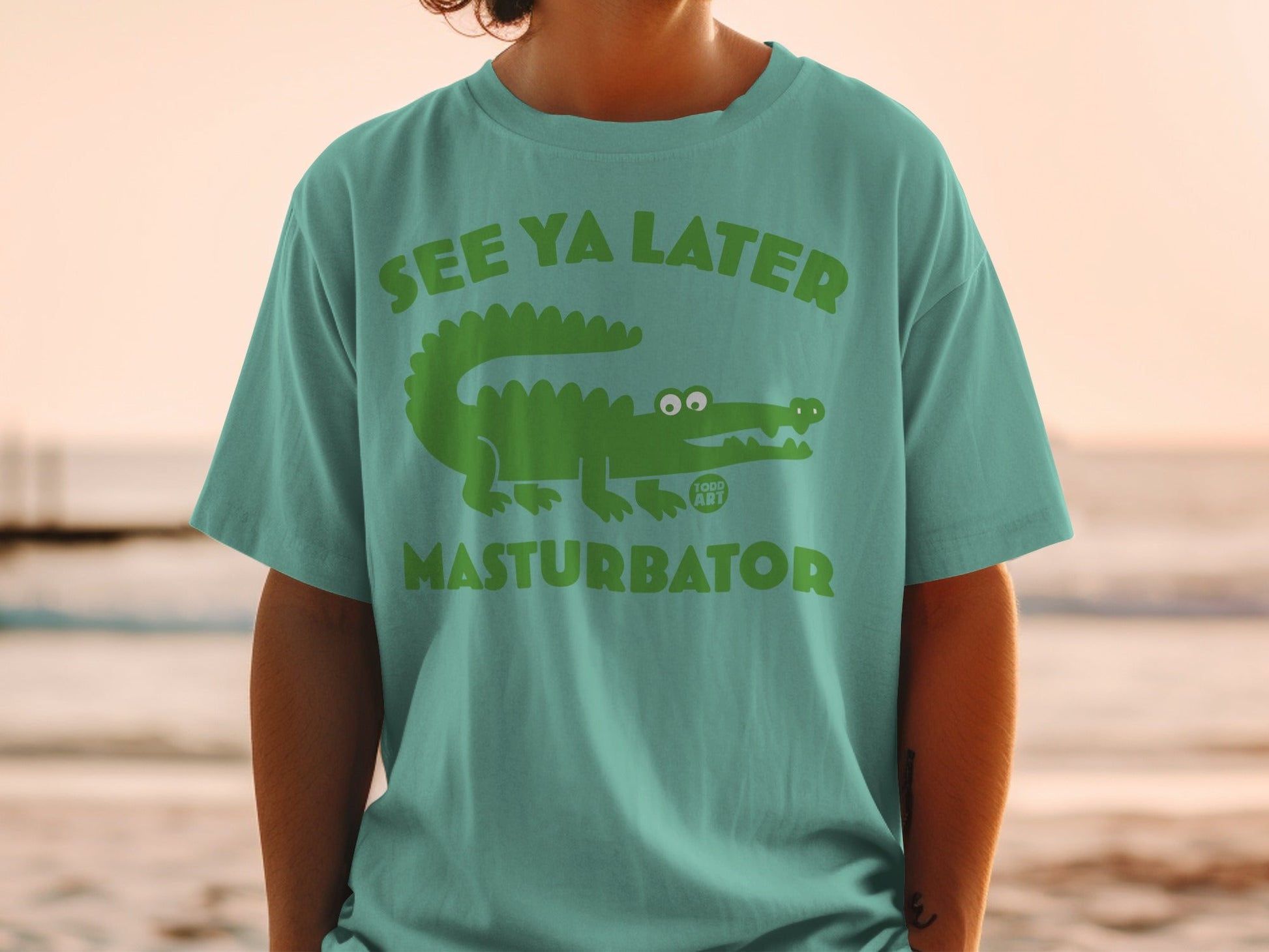 Green t-shirt with cartoon alligator and text "See Ya Later Masturbator".