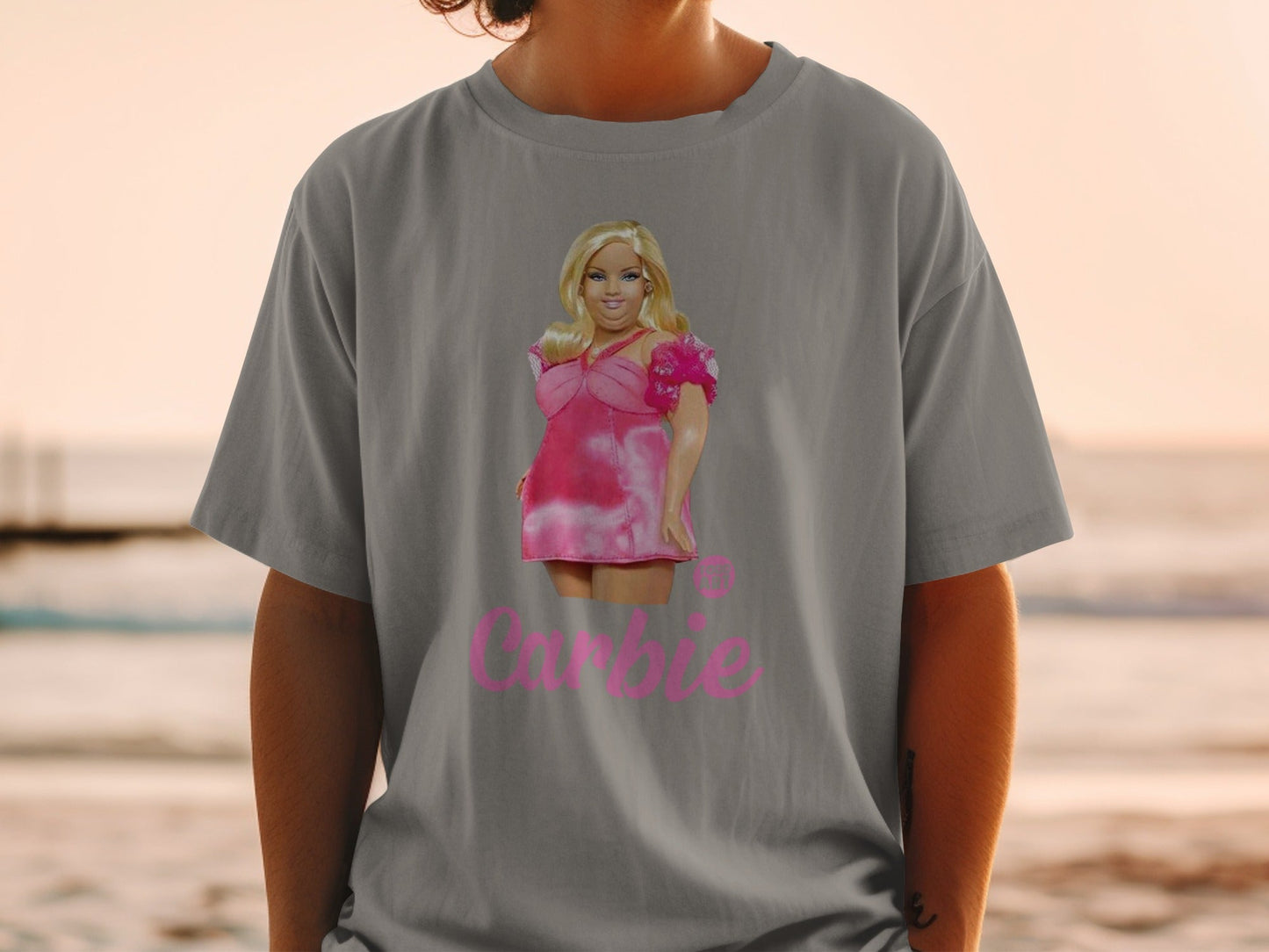 Grey t-shirt featuring Barbie doll illustration in pink dress with "Barbie" text.