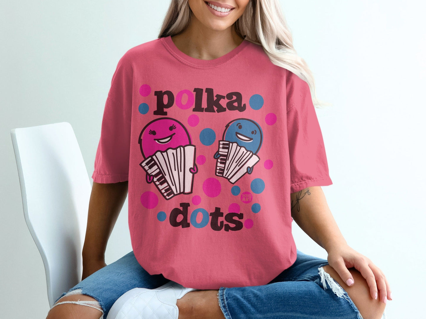 Pink t-shirt with cartoon accordions and "Polka dots" text.