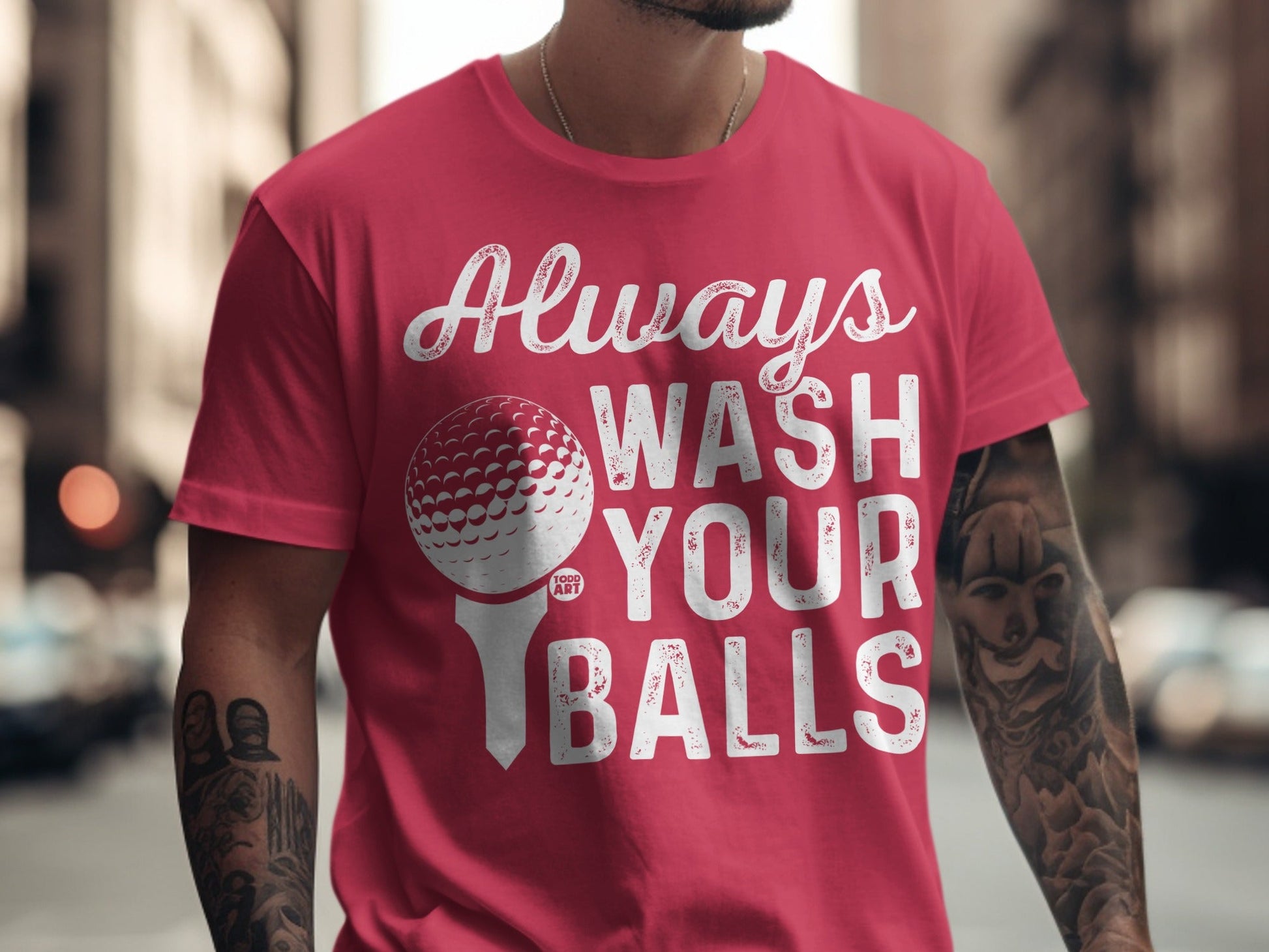 Red t-shirt with "Always Wash Your Balls" text and golf ball graphic.