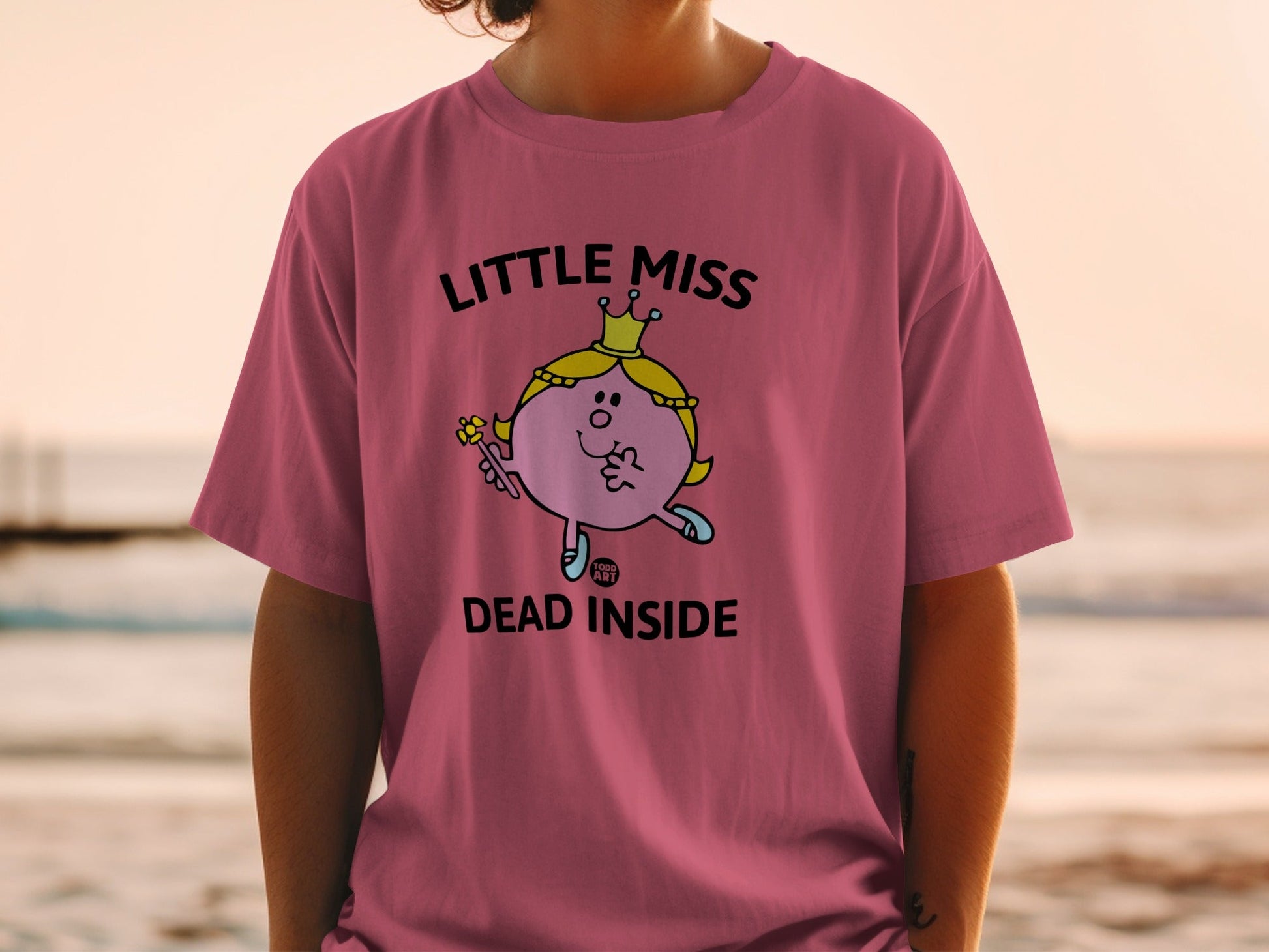 Pink t-shirt with "Little Miss Dead Inside" text and cartoon character.