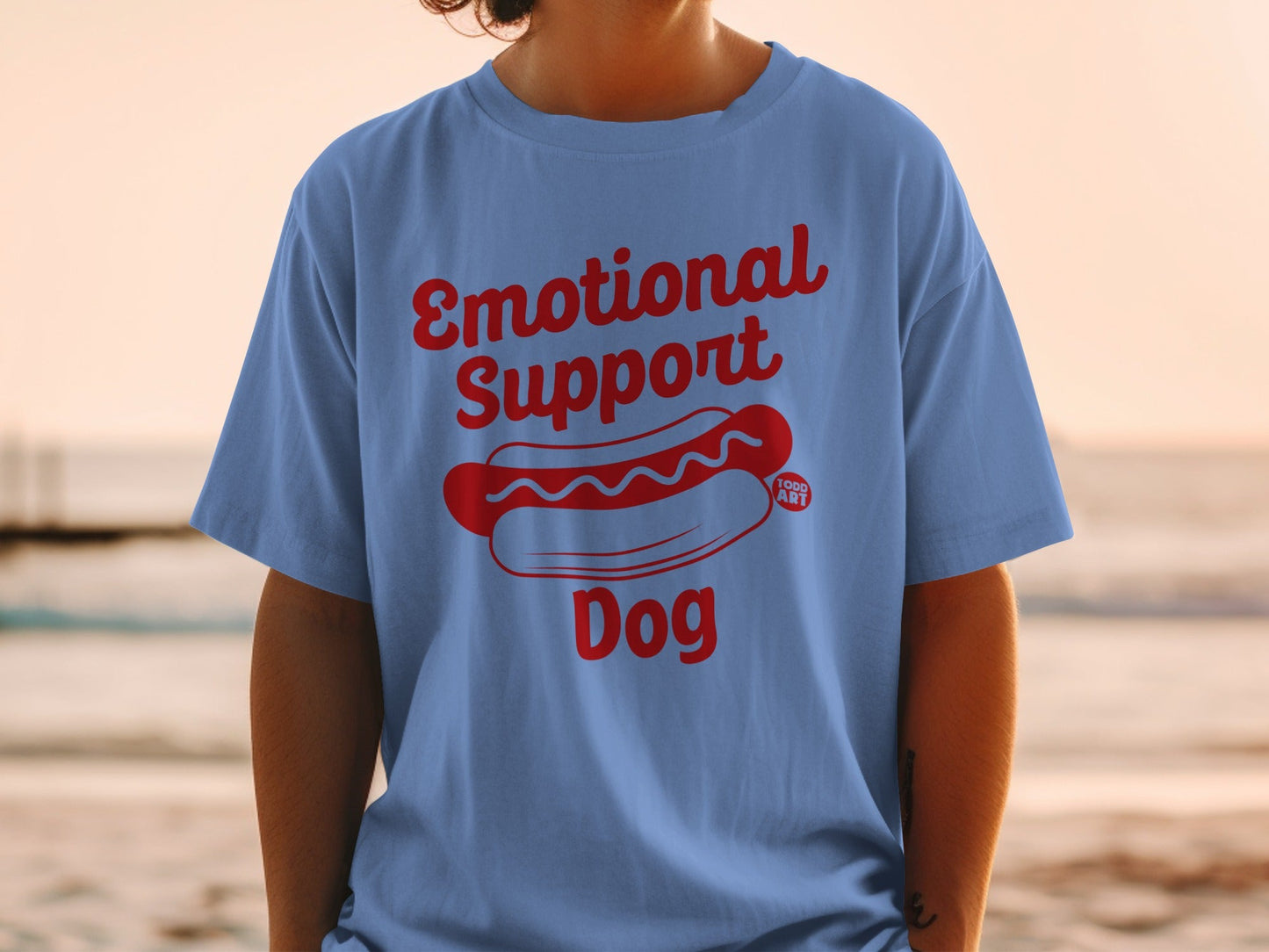 Blue t-shirt with red "Emotional Support Dog" text and hot dog graphic.