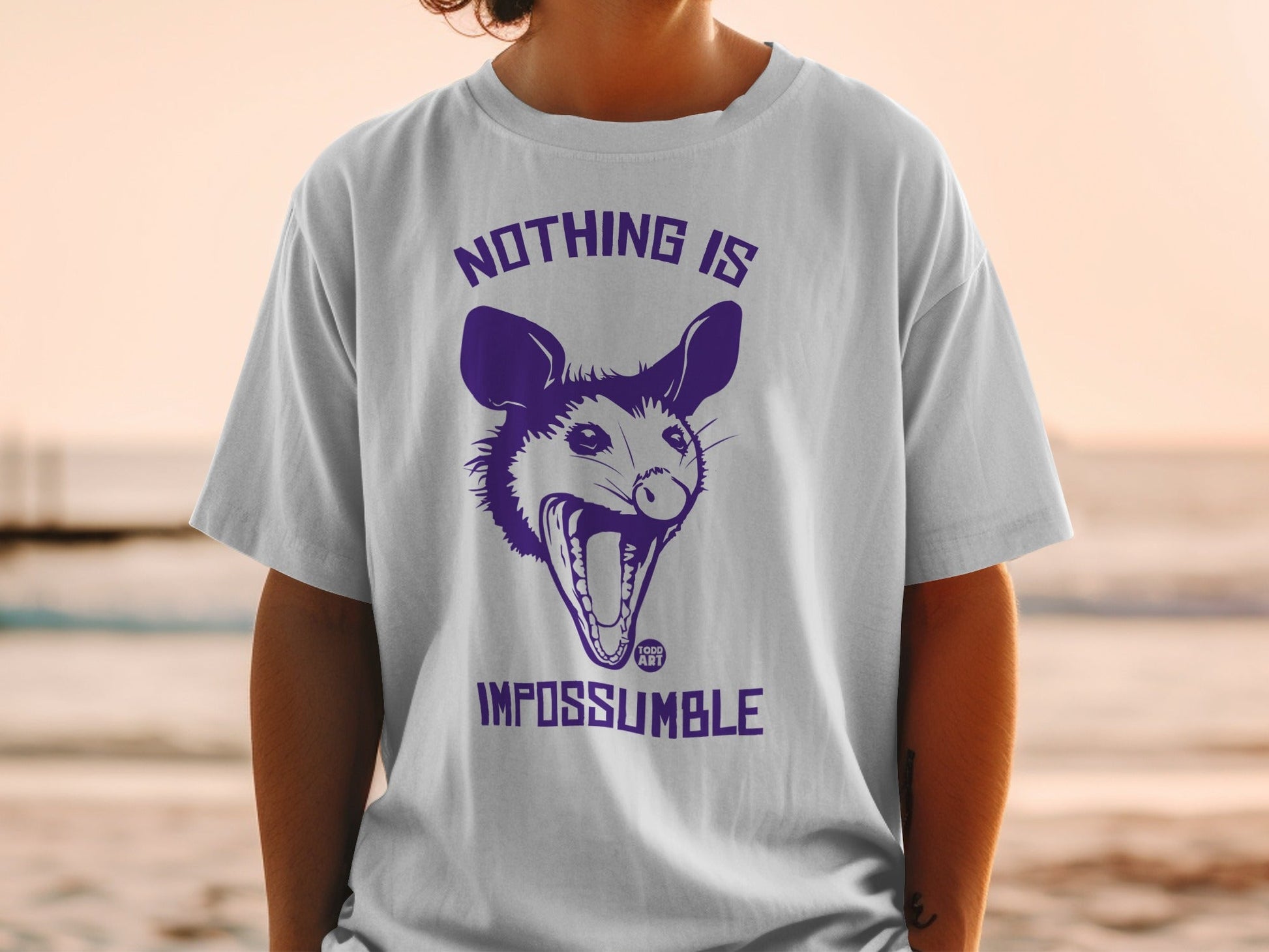 T-shirt with purple possum graphic and "NOTHING IS IMPOSSUMBLE" text.