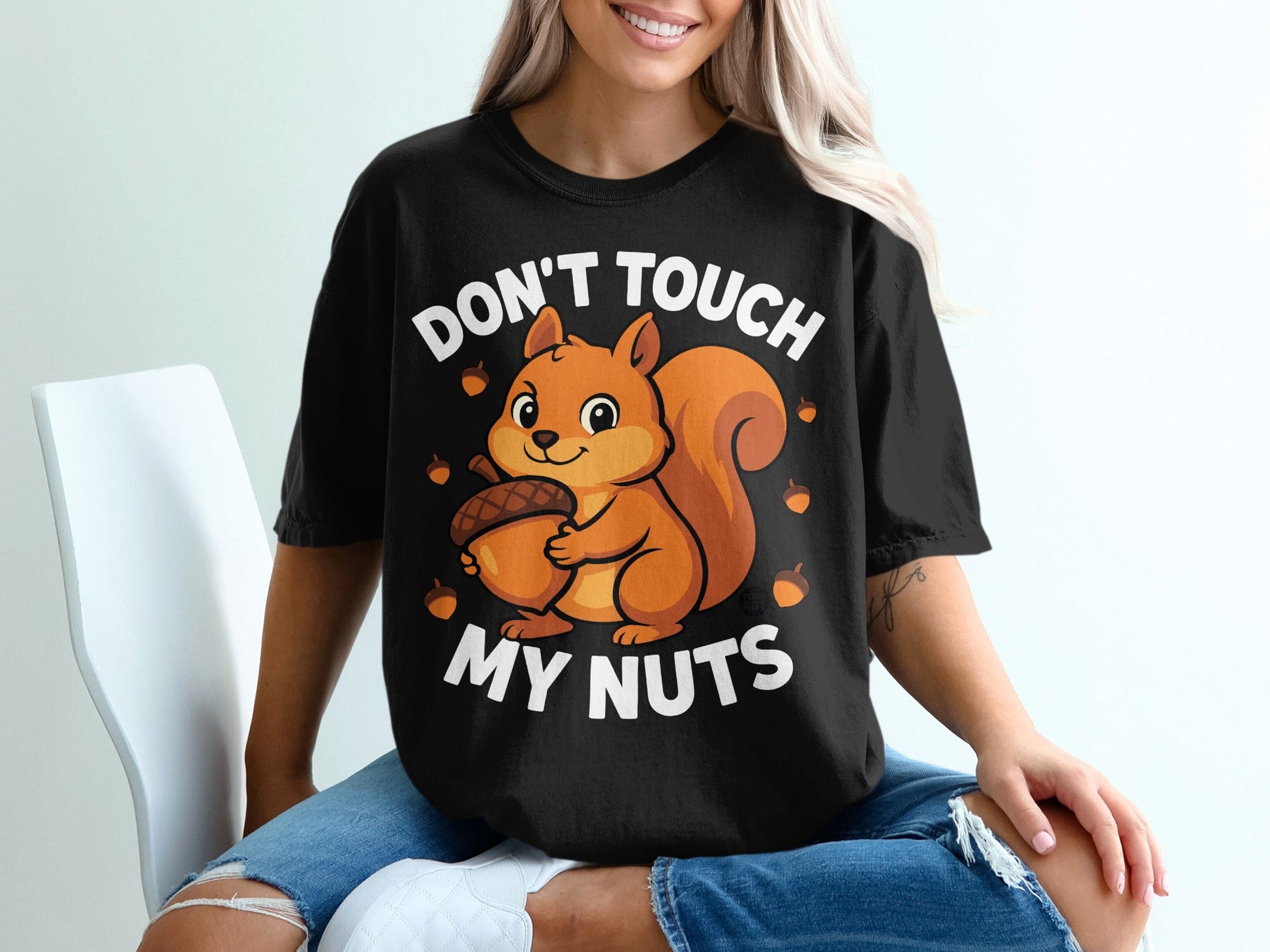 Black t-shirt with a cartoon squirrel holding an acorn and text "Don't Touch My Nuts".