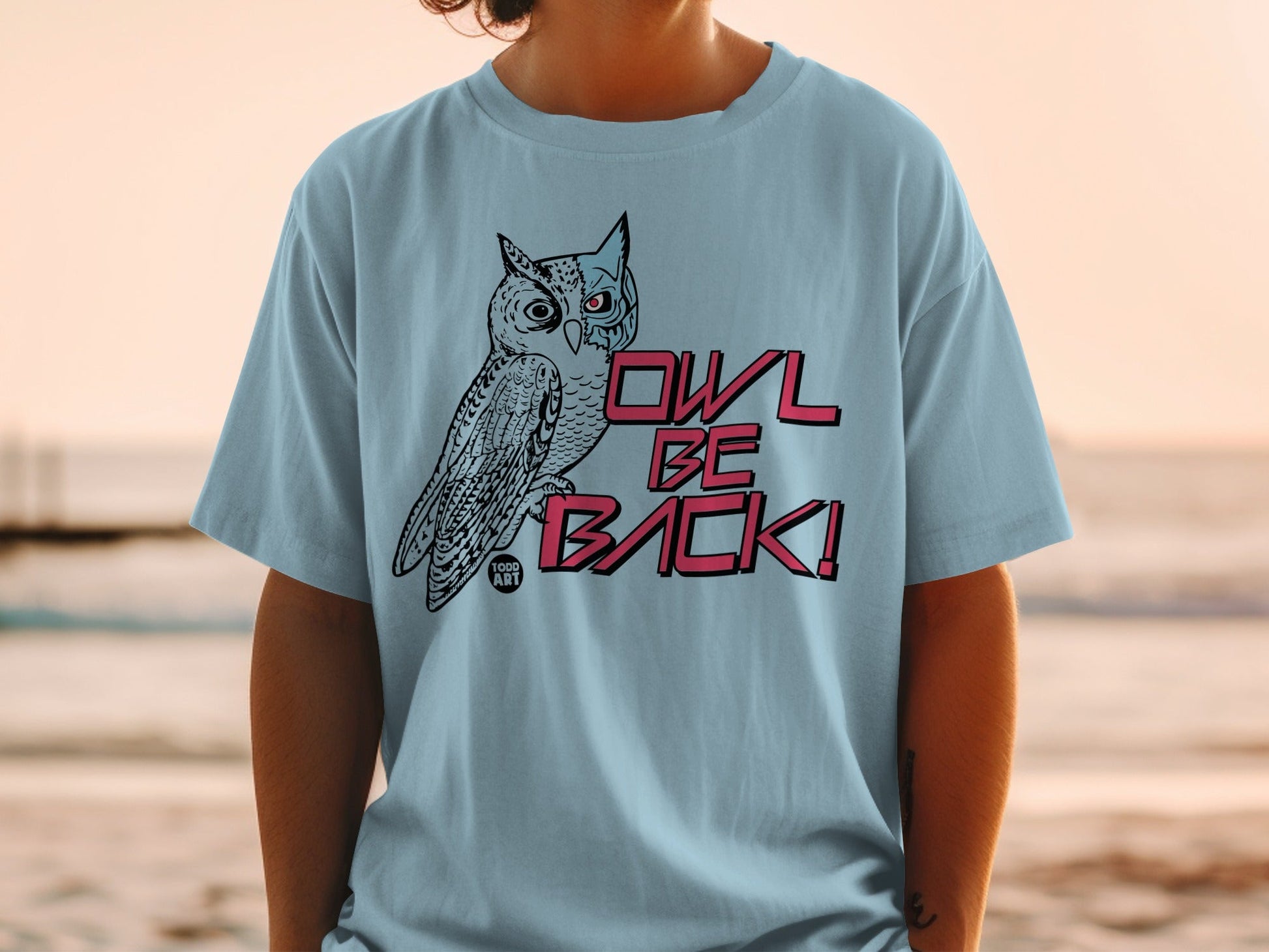 Light blue t-shirt with a cartoon owl and "OWL BE BACK!" text.