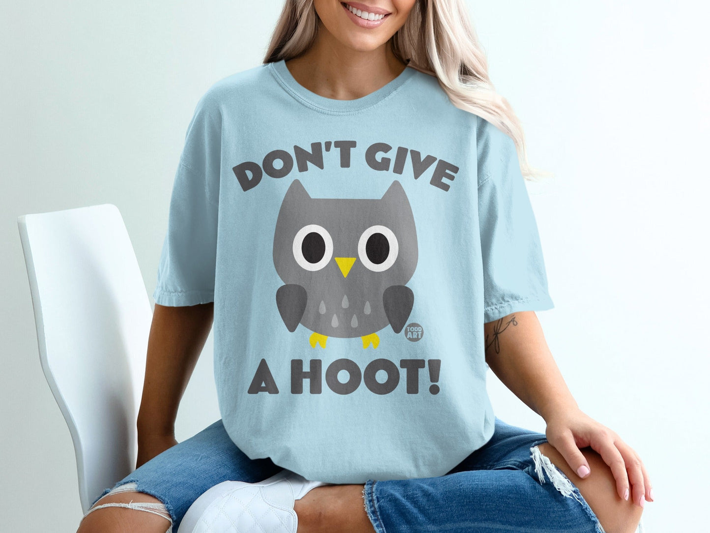 Light blue t-shirt with a cartoon owl and text "DON'T GIVE A HOOT!".