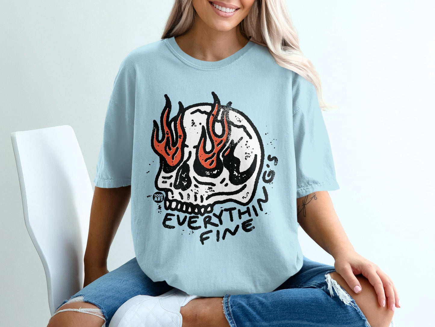 Light blue t-shirt with a skull on fire graphic and text "EVERYTHING FINE".