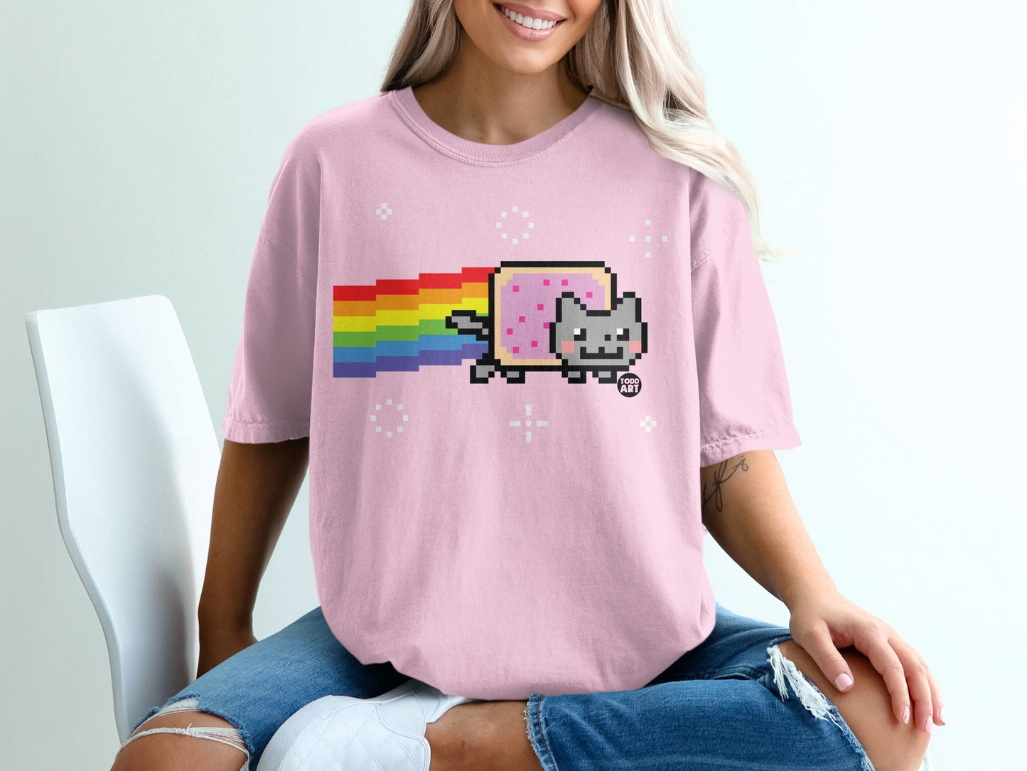 Pink t-shirt with Nyan Cat and rainbow trail graphic.