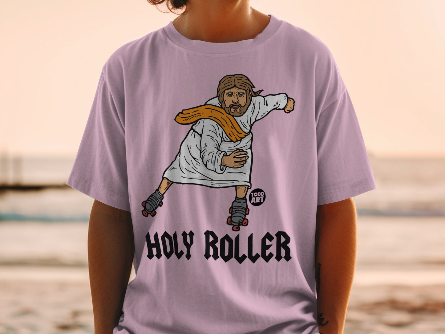 Jesus wearing roller skates and a sash on a pale pink t-shirt.