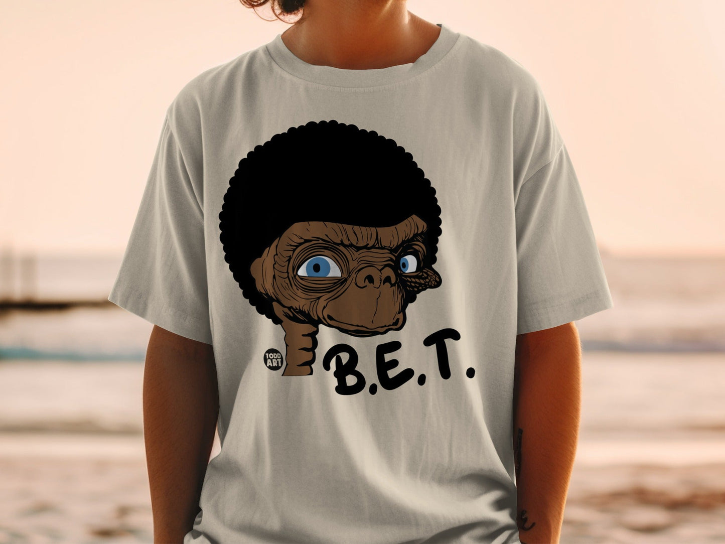 T-shirt with cartoon E.T. face and "B.E.T." text.