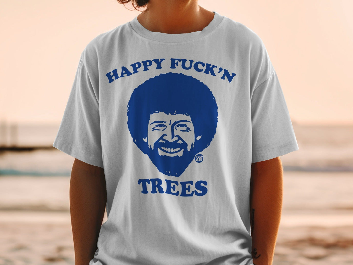 T-shirt with Bob Ross illustration and "Happy Fuck'n Trees" text.
