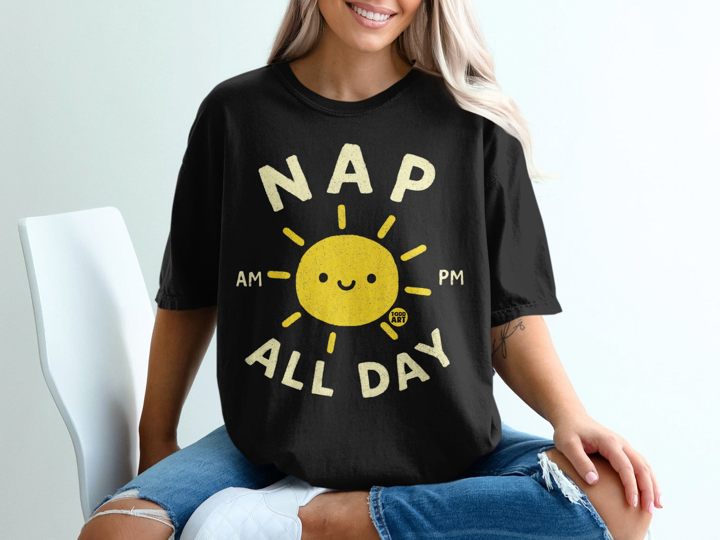 Black t-shirt with yellow sun graphic and text "NAP ALL DAY AM PM".