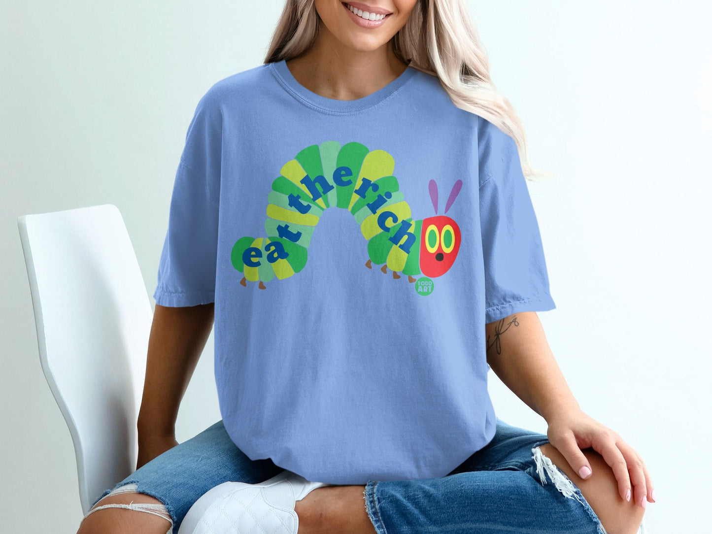 Blue t-shirt with green and yellow caterpillar saying "eat".