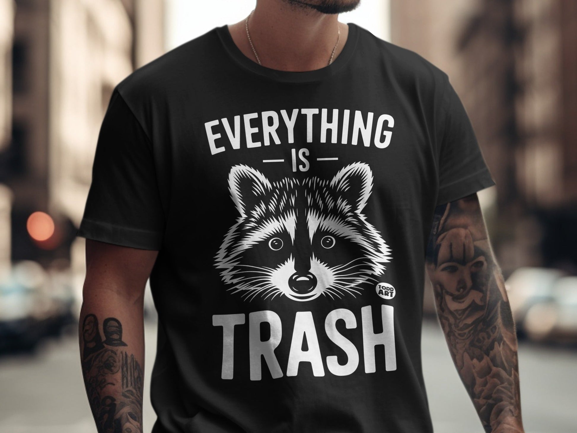 Black t-shirt with raccoon graphic and text "EVERYTHING IS TRASH".