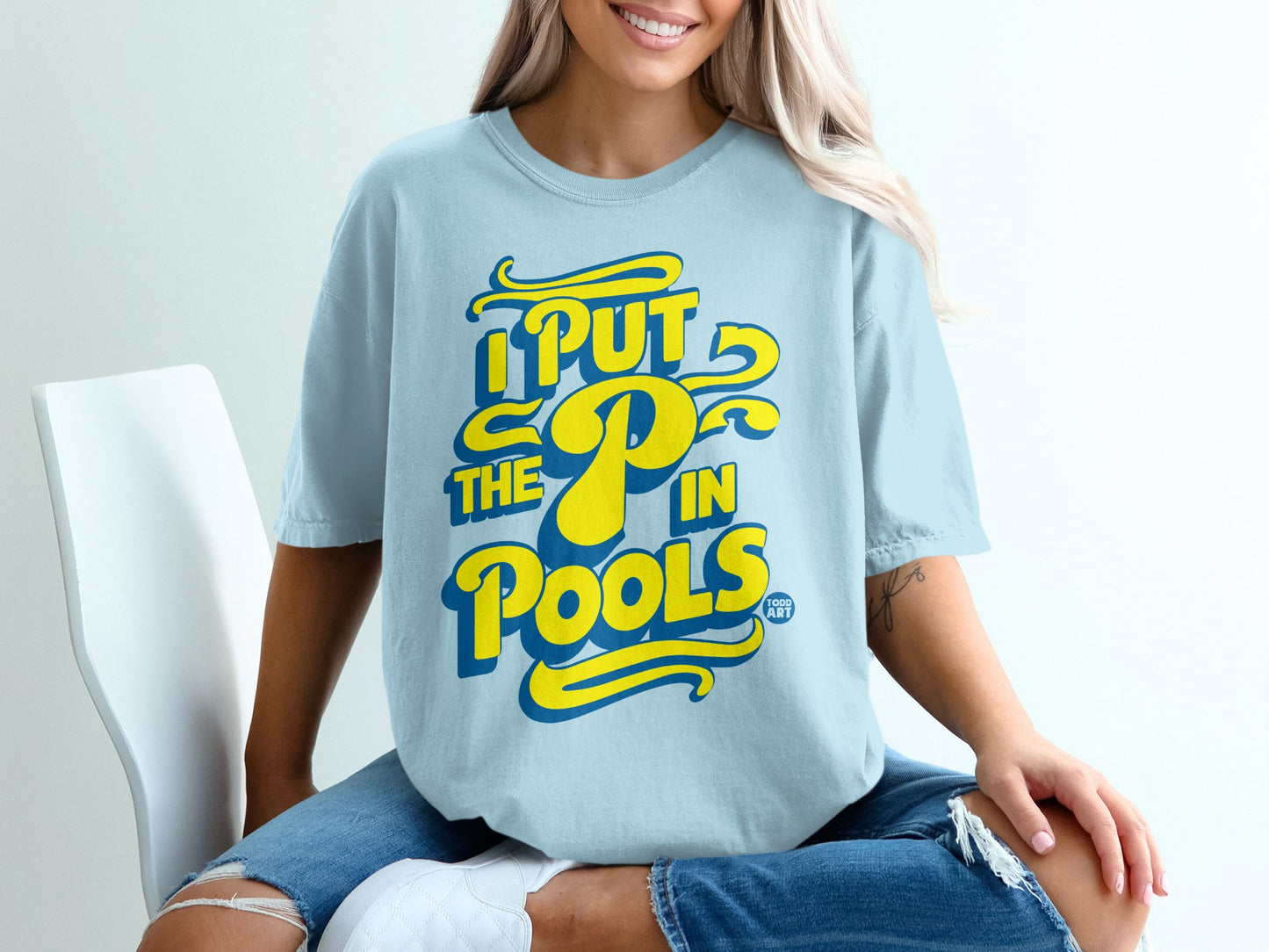 Light blue t-shirt with yellow text: "I PUT THE P IN POOLS".