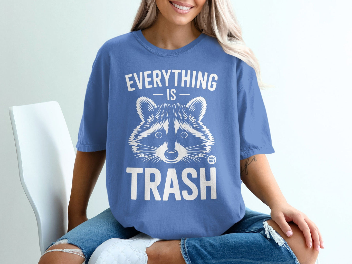 Blue t-shirt with raccoon graphic and "Everything is Trash" text.