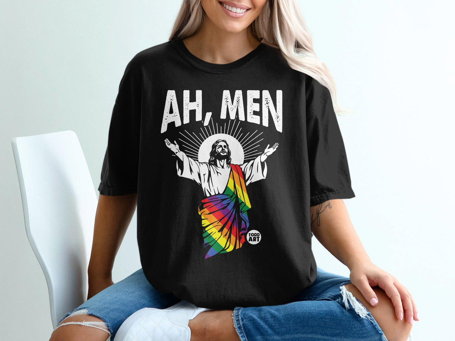 Black t-shirt with Jesus in a rainbow robe, text "AH, MEN" above.