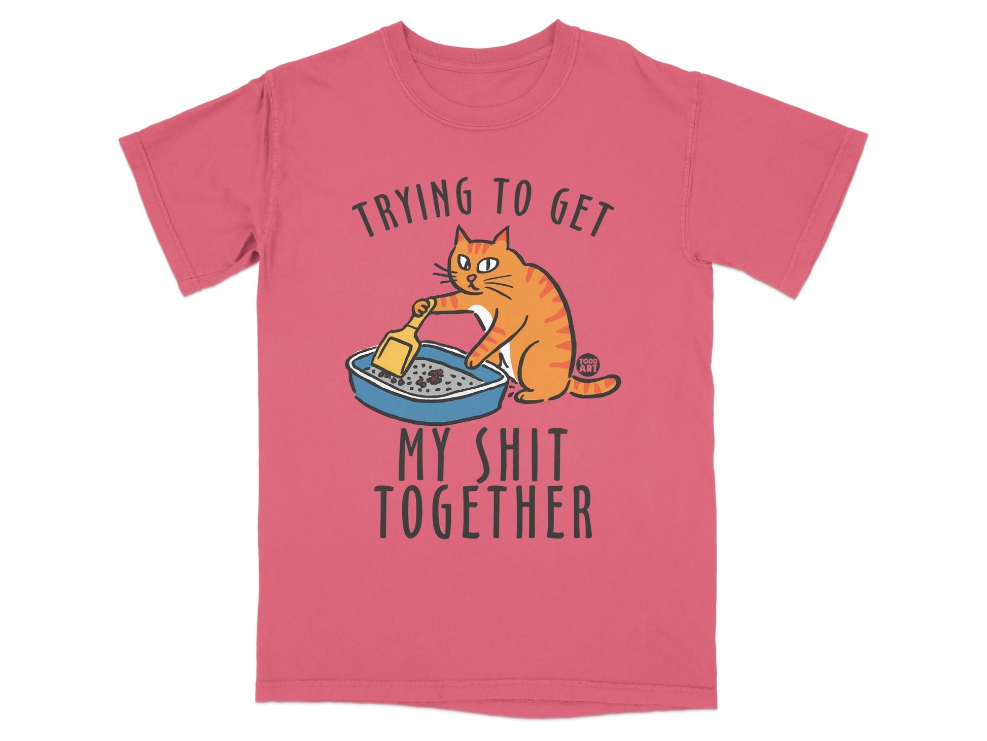 T-shirt with cartoon cat cleaning litter box, text reads "Trying to get my shit together".