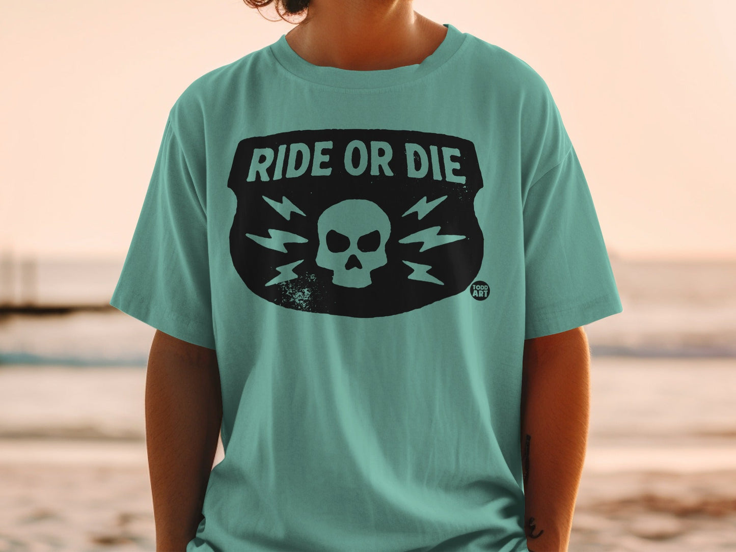 Teal t-shirt with skull and lightning bolt design and "Ride or Die" text.