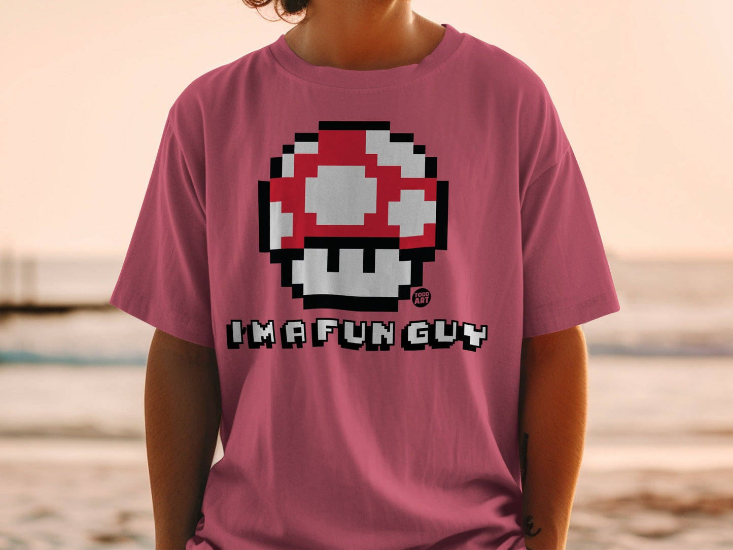 Pink t-shirt with a pixelated red and white mushroom graphic and "IMA FUNG GUY" text.