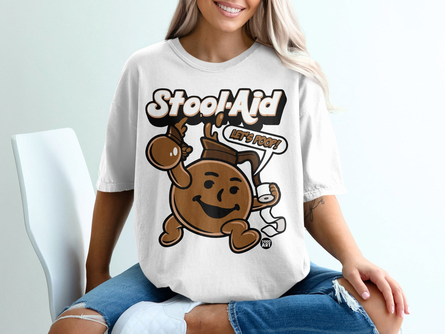 White t-shirt with cartoon Stool-Aid character holding toilet paper and saying "Let's Poop!".