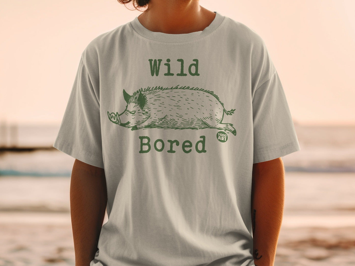 T-shirt with a green wild boar illustration and "Wild Bored" text.