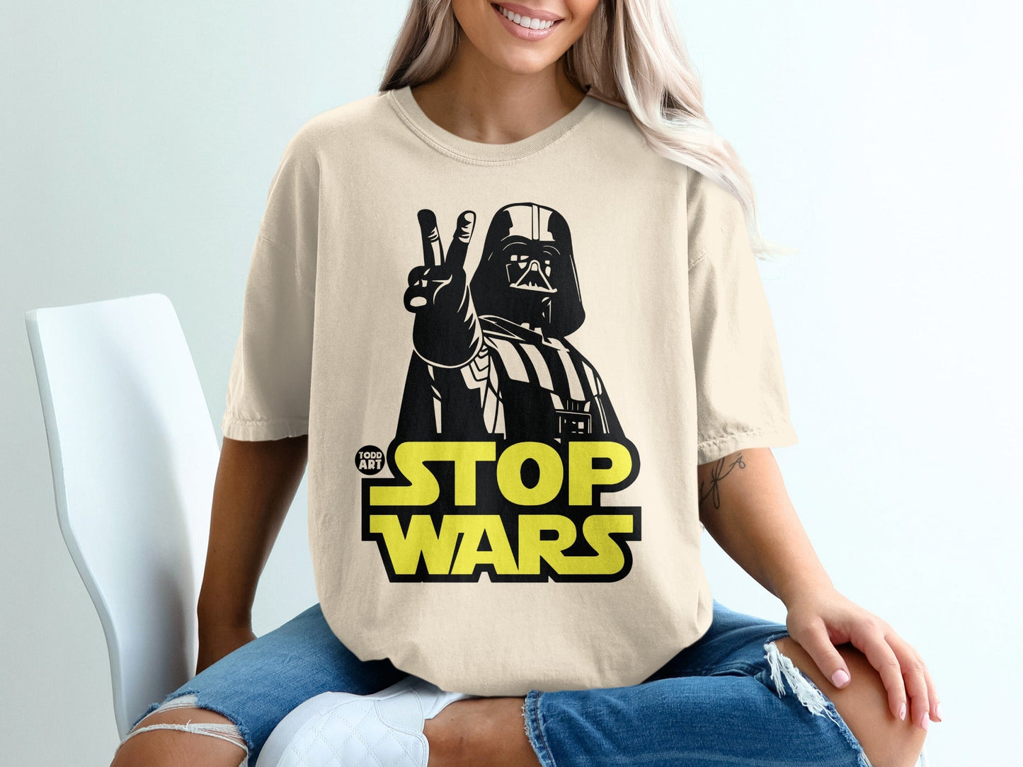 Darth Vader giving a peace sign on a cream t-shirt.